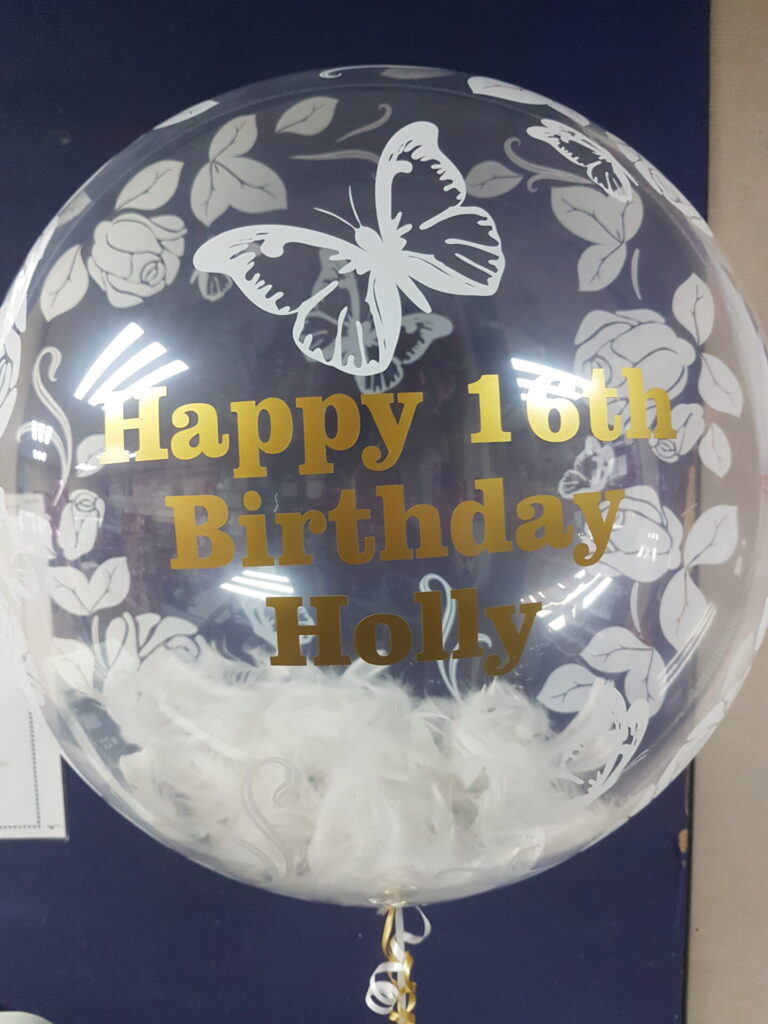 16th birthday bubble balloon with white feathers