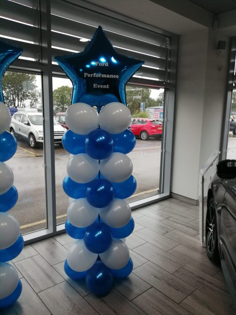 Blue and white balloon pillar with blue star foil balloon