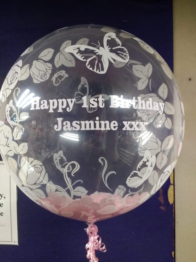 1st birthday bubble balloon with pink feathers