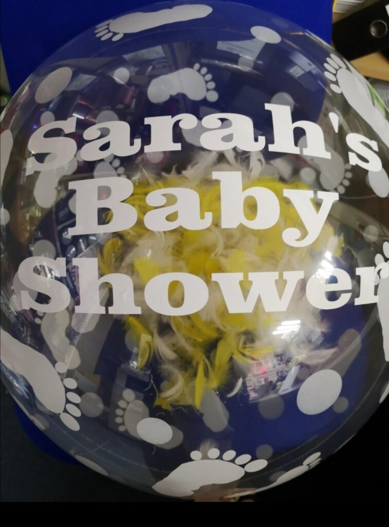 Baby shower bubble balloon with feathers