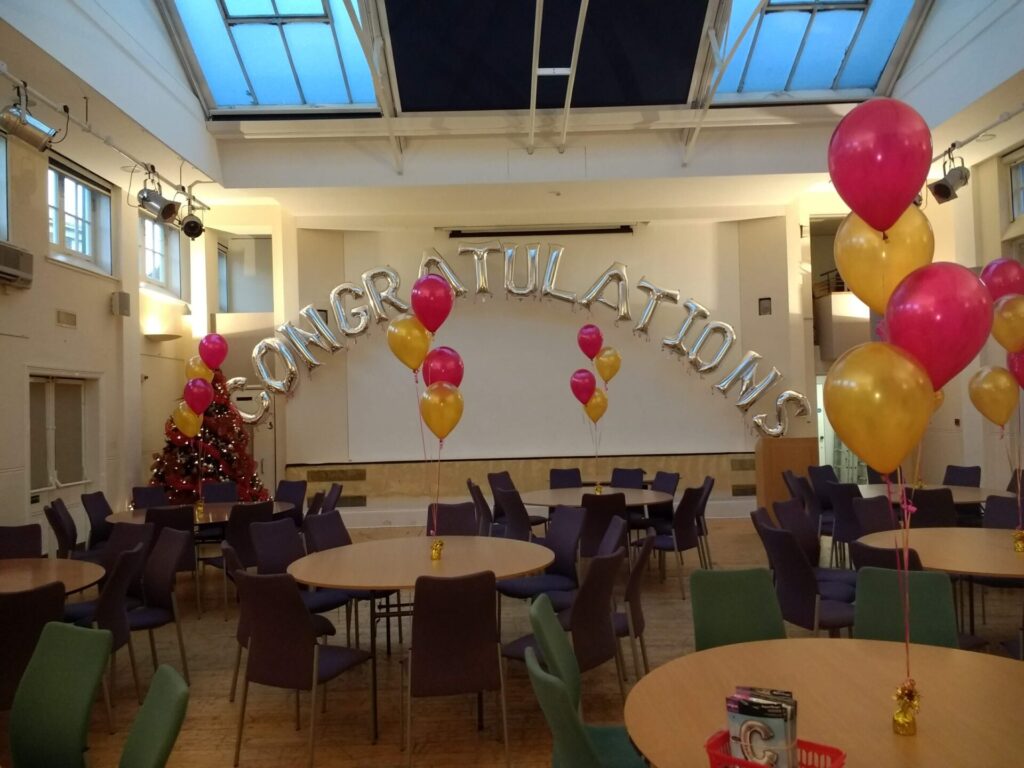 Congratulations silver jumbo letters with pink and gold clusters of 3 balloons