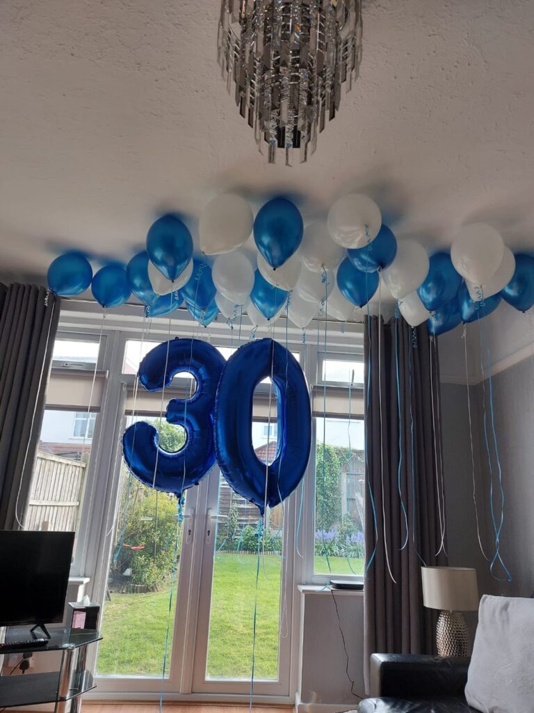 Blue and white ceiling balloons with 30th birthday blue jumbo numbers