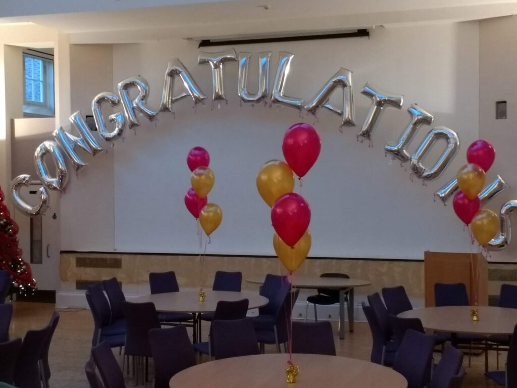 Congratulations giant letter foil balloons with pink and gold clusters of 3 balloons