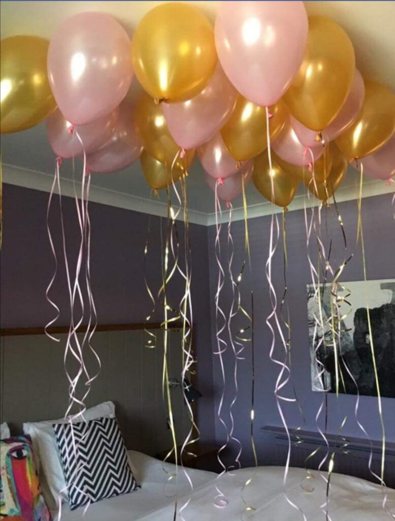 Gold and pink ceiling balloons